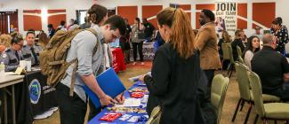 A male PHSC student engaging with an employer at PHSC's Job Fair.